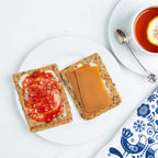 Classic Norwegian Knekkebrød crispbread served with butter, jam, brown cheese, and fresh toppings
