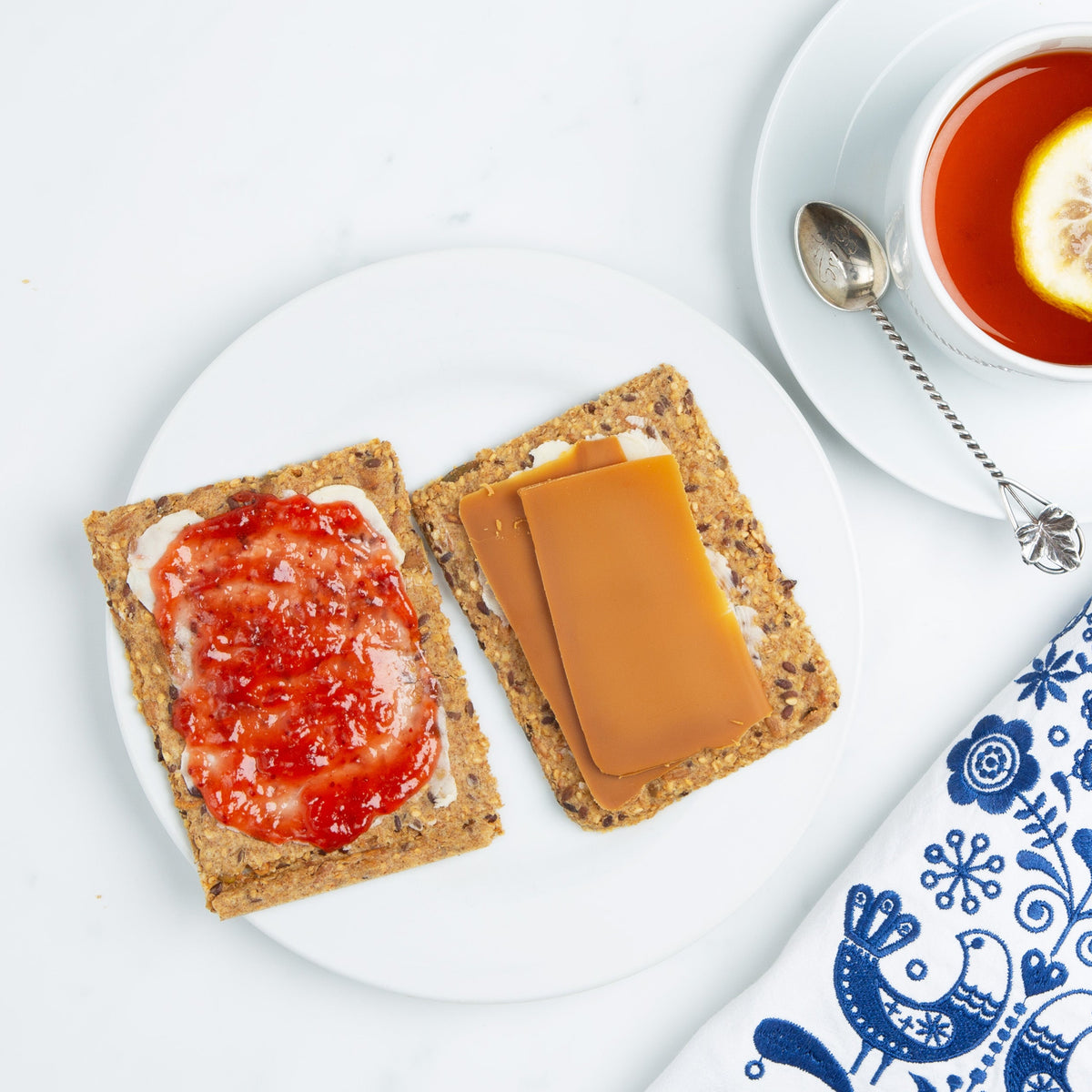 Classic Norwegian Knekkebrød crispbread served with butter, jam, brown cheese, and fresh toppings