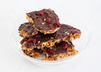 Close-up of KnekkeGodis showing dark chocolate caramel cranberries and sea salt